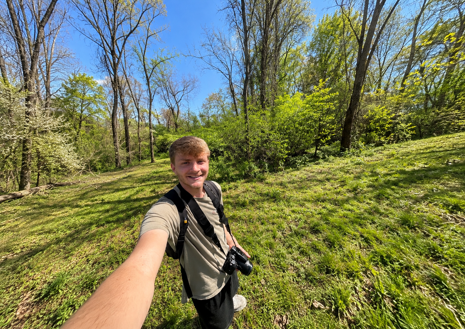 Jacob Shaffer outdoors with a camera while exploring nature